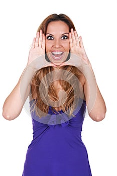 Young woman making surprised face. She is holding hands framed arround head