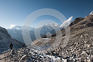 Young woman and man with backpacks after walking the pass on Manaslu circuit with view of Mount Manaslu range 8 156 meters.