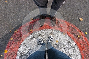Young woman and man facing each other at the streets in a circle, personal pespective - pov