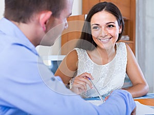 Young woman and man with financial documents in agency