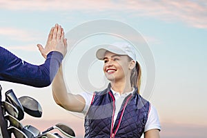 Young woman and man are playing golf