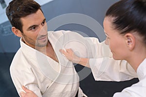 young woman and man practicing martial arts