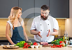 Young woman and man prepare food and host a cooking show. The bloggers stream from modern kitchen. Healthy food