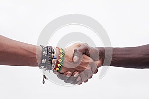 Young woman and man shaking hands, close-up, studio shot