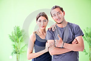 The young woman and man in sports gym