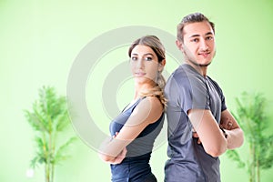 The young woman and man in sports gym