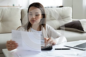 Young woman manage household finances at home