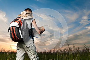 Young woman with map and backpack