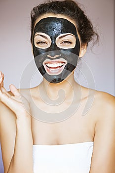 Young woman with a mask for the face of the therapeutic black mu photo