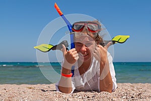 Young woman in a mask and fins for scuba diving with his eyes cl