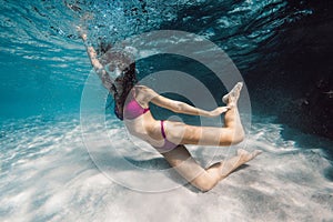 Young woman with mask swimming and fun underwater in transparent ocean