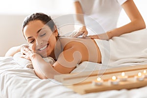 Young Woman During Massage Relaxing Lying In Spa Beauty Salon