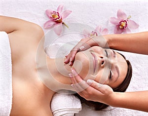 Young woman on massage table in beauty spa.