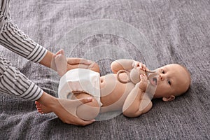 Young woman massaging cute little baby