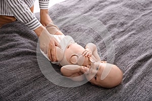 Young woman massaging cute little baby