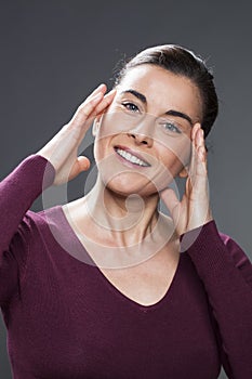 Young woman massaging her face for skin rejuvenation