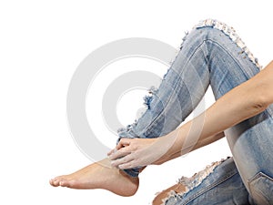 A young woman massaging her painful ankle