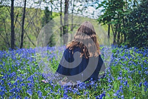 Young woman in meadow of bluebells