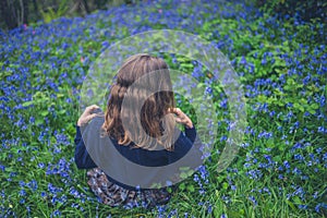 Young woman in meadow of bluebells