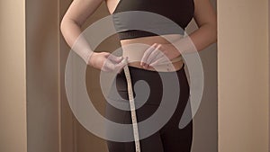 Young Woman Measuring Waist. New Year Resolutions. Biginning New Healthy Life