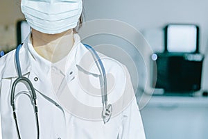 Young woman in medical face protection mask and stethoscope indoors on laboratory background