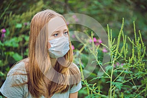 Young woman in a medical mask because of an allergy to ragweed