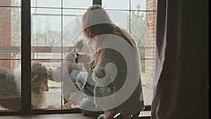 Young woman in medical mask on face visits sick adult girl friend in self-isolation quarantine, safe communication