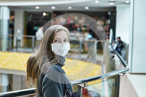 Young woman in a medical mask in a public space