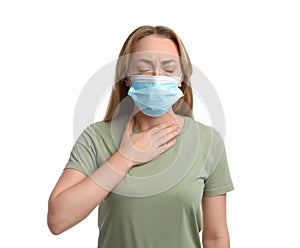 Young woman in medical mask suffering from pain during breathing on white background