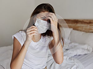 young woman in medical mask tilted her head to the side
