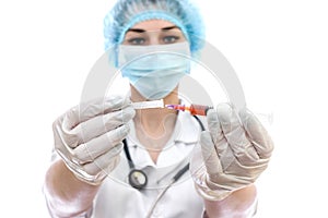 Young woman in medical uniform with syringe isolated on white