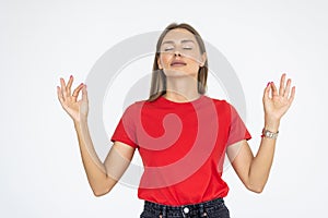 Young woman meditating, holding her hands in yoga gesture, feeling calm and positive, isolated on white studio background, closed