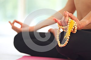 Young woman meditating in lotus pose.