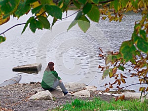 Young woman meditating by the river-Stock Photos