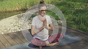 Young woman meditating on rug