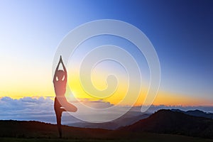 Young woman in a meditating yoga on the beautiful sunset. health