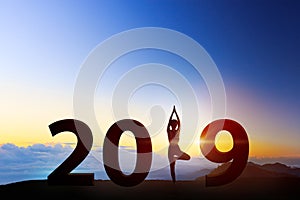 Young woman in a meditating yoga on 2019 new year. healthy concept