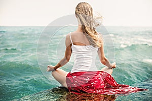 Young woman meditation on the beach