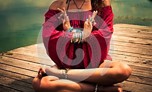 Young woman in a meditative yoga position outdoor photo