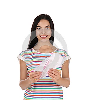 Young woman with menstrual pad and tampon on white background