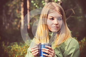 Young Woman with metal touristic tea cup Outdoor