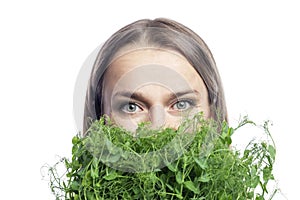Young woman with micro greens near her face. Health, vitamins and natural super food. Close-up. Isolated on white background