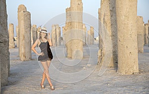 Young woman in a middle of concrete pilings