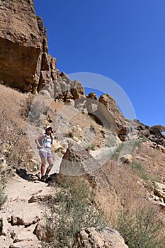 Young woman on Misery Ridge Trail in Smith Rock State Park, Oregon.