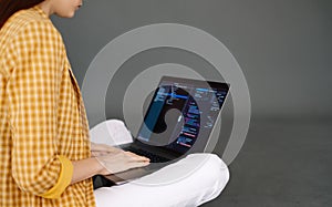 Young woman mobile developer writes program code on a computer, programmer work