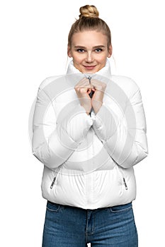 Young woman model posing in white down jacket isolated on white background photo