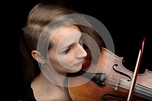 Young woman with modern haircut playing a violin