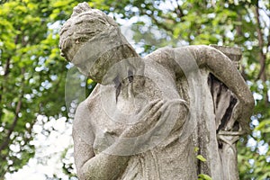 Young woman monument on a tomb at a graveyard in Budapest, Hungary