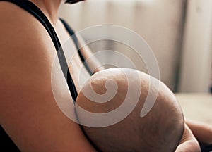 Young woman mother breastfeeding her baby, motherhood natural feeding concept