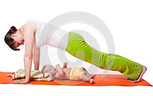 Young woman mother practicing yoga with baby